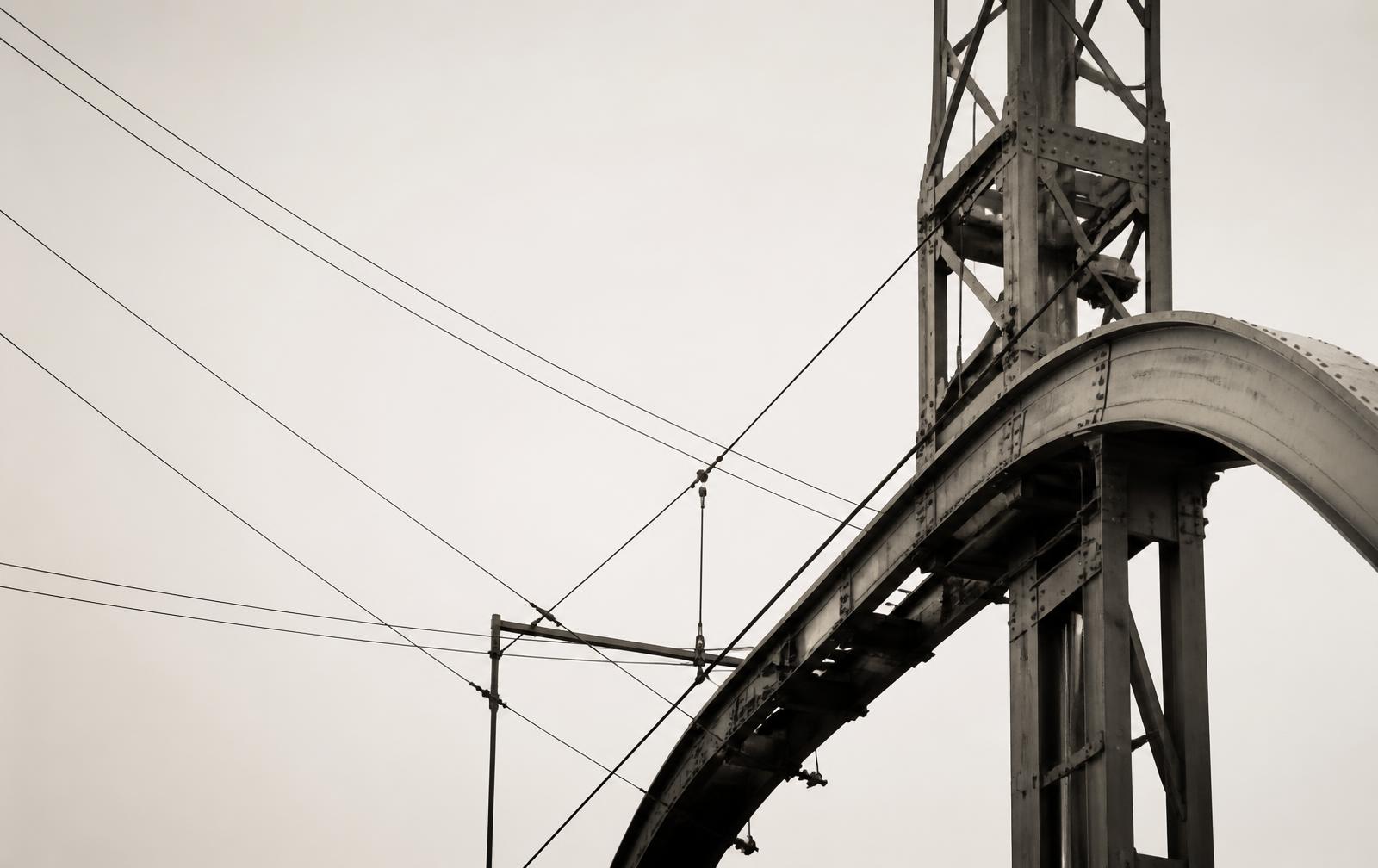 Abstract infrastructure structure spanning across a pale sky